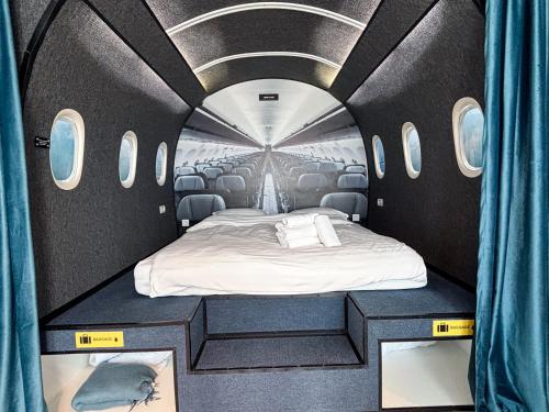 a room with a bed inside of an airplane at Airliner Apartment First Class Stay in Cluj-Napoca