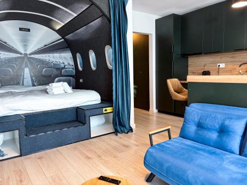 a bedroom with a bed and a couch and a chair at Airliner Apartment First Class Stay in Cluj-Napoca
