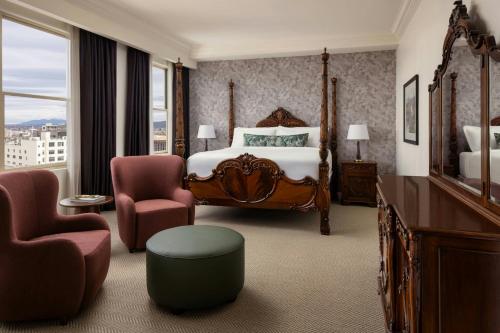 a hotel room with a bed and two chairs at Davenport Hotel, Autograph Collection in Spokane