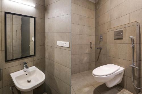 a bathroom with a toilet and a sink at Super Townhouse Gomti Nagar Matiyari in Lucknow