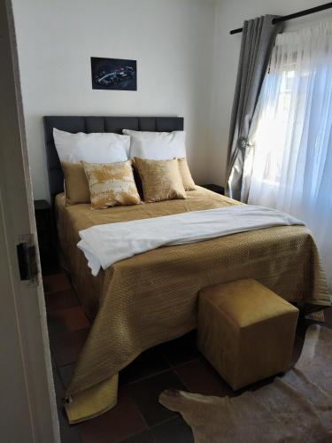 a bedroom with a large bed and a window at The Museum Cottage in Sabie