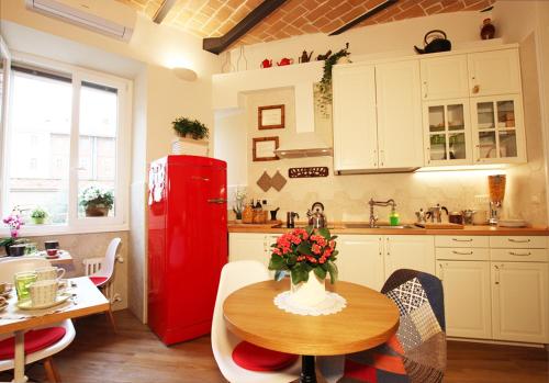 een keuken met een tafel en een rode koelkast bij Campanella3 in Rome