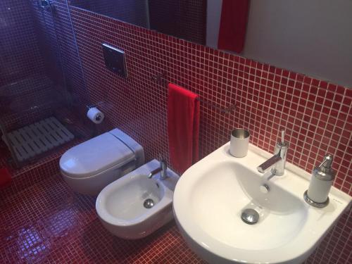 a bathroom with a white sink and a toilet at Ana's Design Apartments in Lisbon