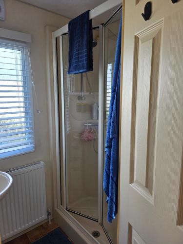 a shower with a glass door in a bathroom at Julie and Shaun's in Ingoldmells