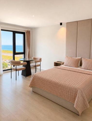 a bedroom with a bed and a view of the ocean at THE DECK OTEL in Trabzon