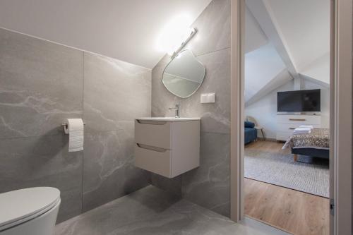 a bathroom with a toilet and a mirror at Pokoje ABC Centrum in Ustka