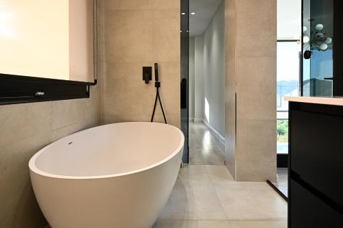 a white bath tub in a bathroom with a shower at Villa 30 Luxury Place Vlore in Fshati i Ri