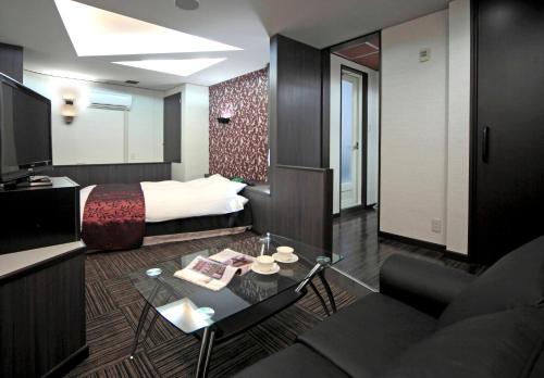 a hotel room with a bed and a living room at HOTEL K's L Adult only in Urigōchō