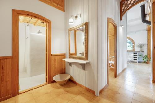 a bathroom with a shower and a mirror at Ca la Crish in Horta de San Joan
