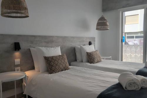 a bedroom with two beds with pillows at RCE Albufeira Spring, Summer & Fall in Albufeira