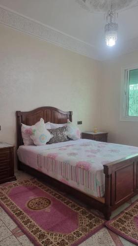 a bedroom with a large bed with pillows on it at Gite El Menzeh in Moulay Idriss