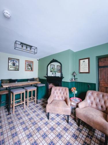 a room with two chairs and a table and a mirror at Red Lion Inn in Milfield