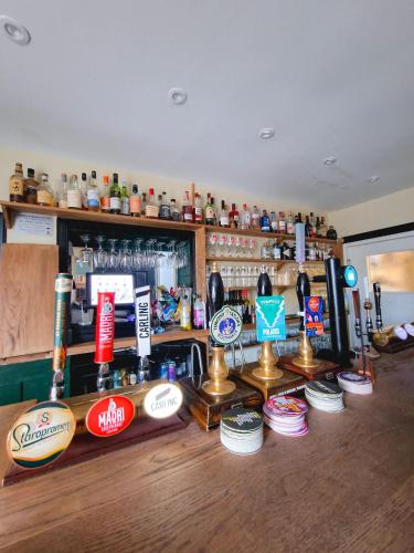 a bar with a lot of signs on the counter at Red Lion Inn in Milfield
