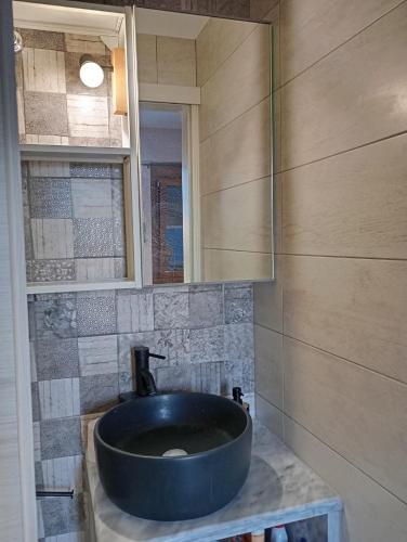 a bathroom with a large blue sink on a counter at Evriaki Rooms Lesvos in Apidias Lakos