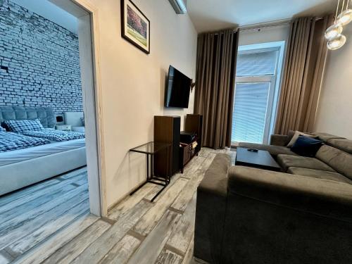 a living room with a couch and a bed at Royal City Centre Apartment - 2 Bedrooms 72 m2 - AC - Balcony - Coffee Machine - Washer - Dryer -Parking available Free public or Paid Private for 20 euro per stay Please read our emails in Poprad
