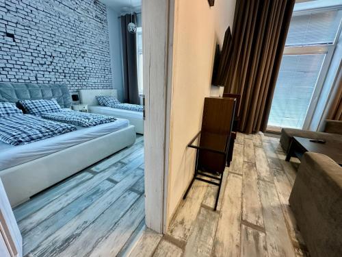a room with a bed and a couch in it at Royal City Centre Apartment - 2 Bedrooms 72 m2 - AC - Balcony - Coffee Machine - Washer - Dryer -Parking available Free public or Paid Private for 20 euro per stay Please read our emails in Poprad
