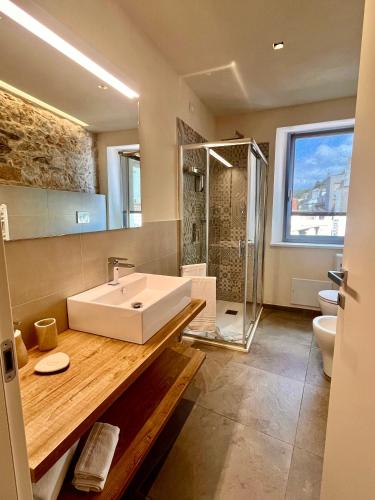 a large bathroom with a sink and a shower at Goloritzè Room and Breakfast in Baunei