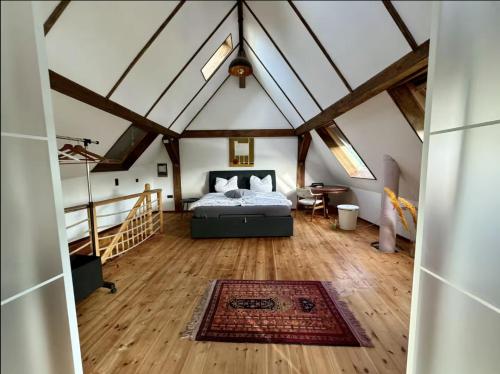 a bedroom with a bed in a attic at Das besondere Moselhaus-Mosel ultranah Luxus Ferienhaus Mosel in Kinheim