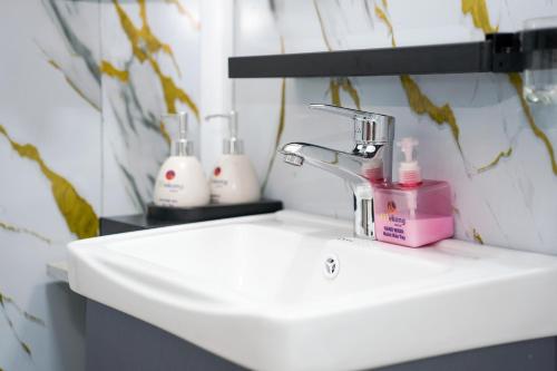 a bathroom sink with two soap bottles on it at Mekong Hotel in Tây Ninh