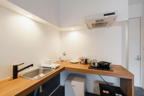 a kitchen with a sink and a counter top at HIT Tenjin in Fukuoka