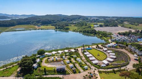 an aerial view of a park next to a lake at Taean Bibi ArtGlamping in Taean
