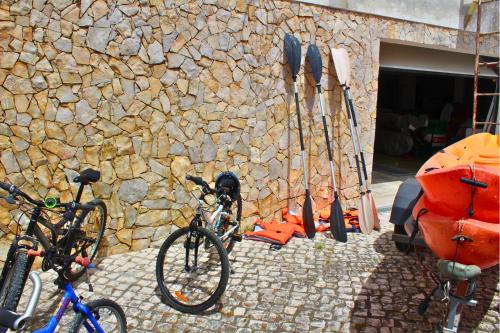 two bikes parked in front of a stone wall at Villa Penim - Countryside Villa with Jacuzzi, Garden with BBQ & Stunning Views in Sesimbra