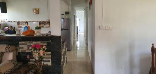 a living room with a kitchen and a table with flowers at Bethany in Riche Bois