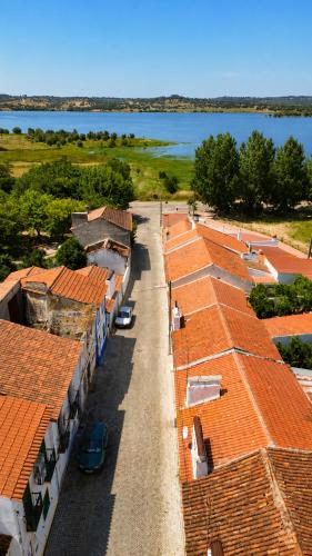 an aerial view of roofs of buildings with a lake at Casa de Benavila in Benavila