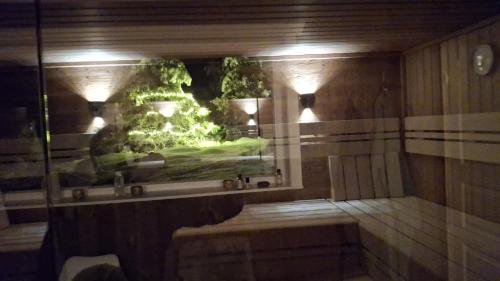 a bath room with a shower with a fish tank at Uplandhytta in Ringsaker