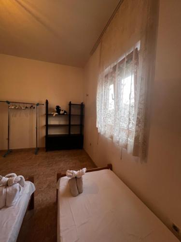 a room with two beds and a window at Obala Ineks in Sutomore