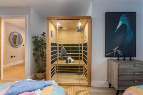 a bedroom with a closet with a bird on the wall at Luxury Sea View Apartments in Bude with Garden, Sleep 6 in Bude