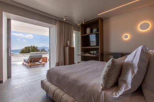 a bedroom with a bed and a view of the ocean at Santana Beach in Agia Anna Naxos