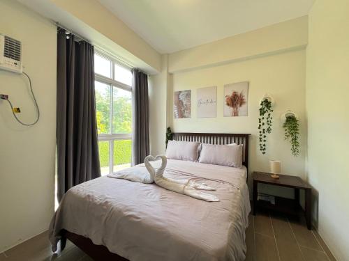 a bedroom with a bed with a large window at Oceanview Condo in Boracay in Boracay