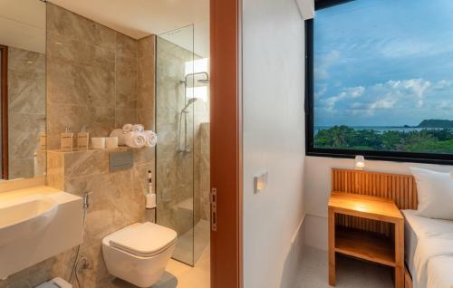 a bathroom with a shower and a toilet and a sink at CASA MIA - Luxury Apartments Central Kuta in Kuta Lombok
