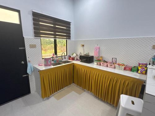 a kitchen with a sink and a counter top at HomestayDino in Kuala Terengganu