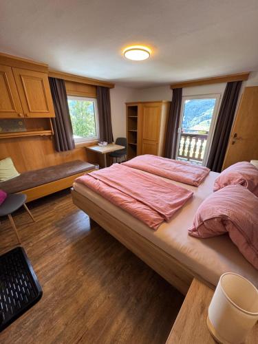 a bedroom with a large bed in a room at Landhaus Aigner in Mittersill