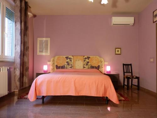 比薩的住宿－Elisir b&b，一间卧室配有一张带橙色毯子的床