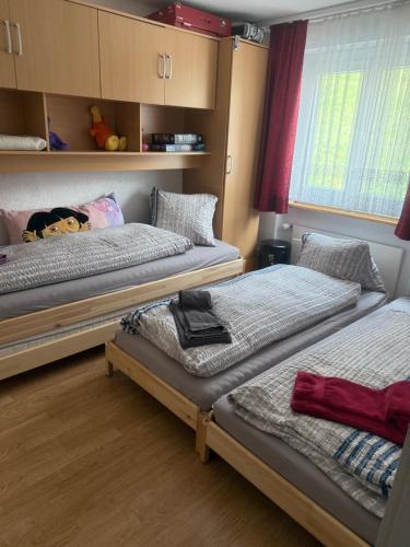 a room with three beds and a window at Eldorado 47 grosse Wohnung mit Wunderschönen Aussicht in Leukerbad