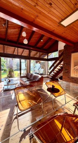 a living room with glass tables and a couch at Lake front, Mid-century house with sauna 2 in Budgewoi