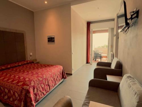 a bedroom with a red bed and a living room at Albergo Ristorante Monterosa in Ameno