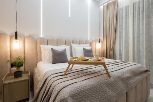 a bedroom with a large bed with a tray on it at SunWhite Villas - Private Pool & Cozy Atmosphere, by ZanteWize in Laganas