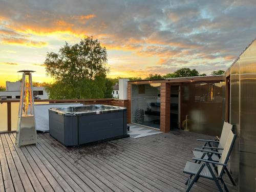 a hot tub on the deck of a house at Rooftop Spa Villa Kuressaare in Kuressaare