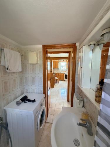 a bathroom with a washing machine and a sink at Molyvos Sunset Horizon in Mythimna