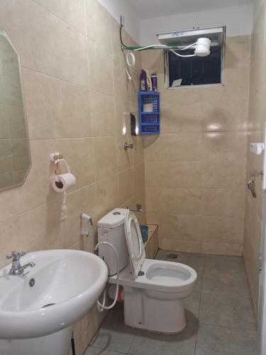 a bathroom with a toilet and a sink at PAZURI - Homes2 in Voi