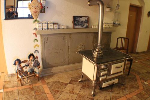 a kitchen with a stove and dolls in a room at Reiterhof Könning in Freren