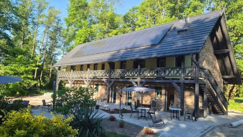 a large wooden house with tables and chairs at Stara Broznja in Burg