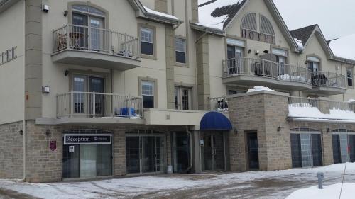 a hotel in the winter with snow on the ground at Condo St Sauveur in Piedmont