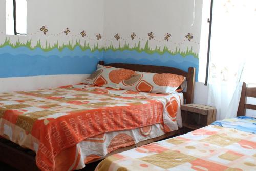 a bedroom with a bed with a blue headboard at Hostería - Bodega Valle Divino in Uriondo