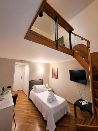 a bedroom with a large bed with a loft at Hotel Europa in Taranto