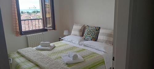 a small bedroom with a bed with towels on it at Maisonette Agata in Toscolano Maderno